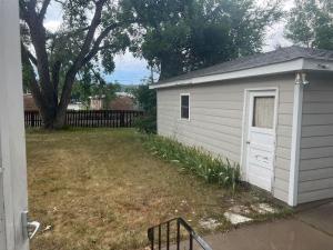 a small white shed sitting in a yard at Spacious 4 bedroom residential at Burlington Park in Billings