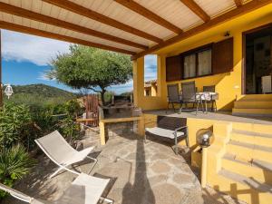a patio with chairs and a grill on a house at VILLA CLAUDIO e LUNETTA in Villasimius