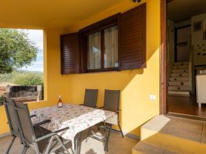 a table and chairs on the balcony of a house at VILLA CLAUDIO e LUNETTA in Villasimius