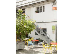 a patio with tables and chairs and a staircase at Basel Backpack in Basel