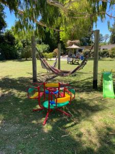 a playground with a hammock in a park at Icalma De La Sierra in Tandil