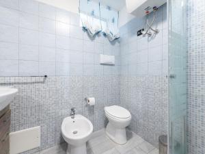 a bathroom with a toilet and a glass shower at VILLA CLAUDIO e LUNETTA in Villasimius
