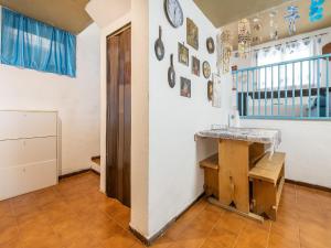 a room with a table on the wall and a staircase at VILLA CLAUDIO e LUNETTA in Villasimius