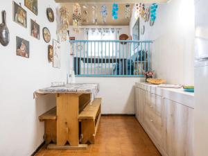 a kitchen with a counter and a table in a room at VILLA CLAUDIO e LUNETTA in Villasimius