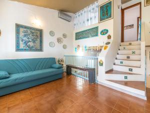 a living room with a couch and a staircase at VILLA CLAUDIO e LUNETTA in Villasimius