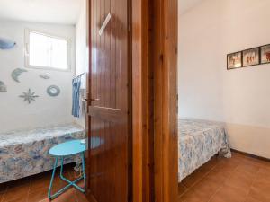 a room with a door and a bed and a table at VILLA CLAUDIO e LUNETTA in Villasimius