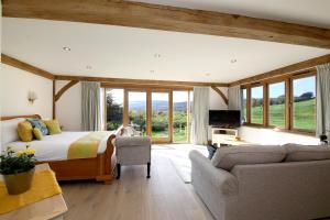 a bedroom with a bed and a living room at Exclusive Use of A Barn in Arundel
