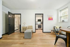 a living room with a table and chairs and a kitchen at HostWise Stays - Butler St - Private Entrance on Ground Floor - Lower Lawrenceville in Pittsburgh