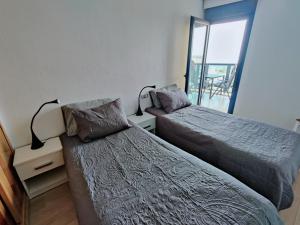 a bedroom with two beds and a balcony at Vista al Mar, Ferienwohnung, Traumhafter Meerblick, Seaview in Torrevieja +17 photos