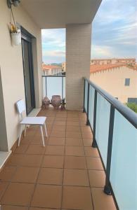 a balcony with a bench and a view of the ocean at Apartamento Golf PANORAMICA in Sant Jordi