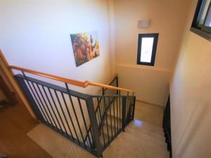 einen Flur mit einer Treppe mit zwei Bildern an der Wand in der Unterkunft Apartamento Golf PANORAMICA in Sant Jordi