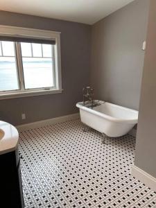 a bathroom with a white tub and a window at Smooth Sailing on Lake Champlain in NY! in Plattsburgh +22 photos
