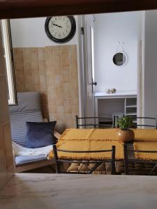 a room with two beds and a clock on the wall at Casas dos Avós in Nazaré