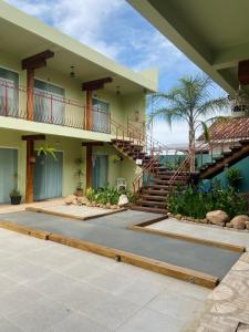 a house with a staircase and a patio at Hotel Zona Sul in São Gabriel