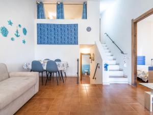a living room with a couch and a table at VILLA CLAUDIO e LUNETTA in Villasimius