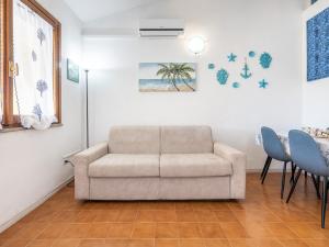 a living room with a couch and a table at VILLA CLAUDIO e LUNETTA in Villasimius