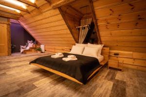 a bedroom with a bed in a wooden room at Nadleśniczówka - Bieszczadzka Zagroda in Weremień