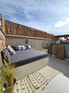 a bed sitting on top of a patio at Riad les Rêves d'Amélie in Marrakesh