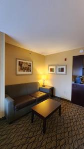a living room with a couch and a coffee table at Wingate by Wyndham Kittanning in Kittanning