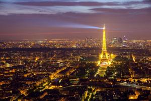 a view of the eiffel tower at night at Luxury Flat With Terrace & Eiffel Tower View in Paris