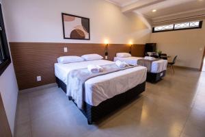 Säng eller sängar i ett rum på CAMBUI Apartamentos para até 4 pessoas