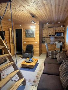 a living room with a couch and a table at Sisaliku Puhkemaja saunaga in Luke