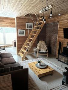 a living room with a staircase and a brick wall at Sisaliku Puhkemaja saunaga in Luke