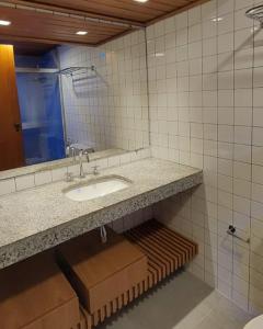 a bathroom with a sink and a mirror at Sol Vicitoria Marina in Salvador