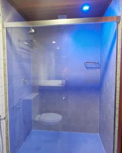 a bathroom with a glass shower with a toilet at Sol Victoria Marina in Salvador +6 photos