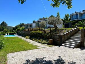 a garden with stairs and a swimming pool at Turismo Natureza Villa Rio in Castanheira de Pêra