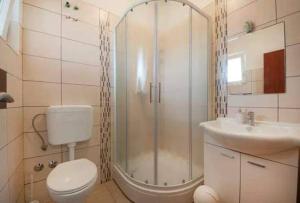 a bathroom with a shower and a toilet and a sink at Apartments & Rooms Krecak Sibenik in Šibenik