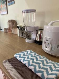 a kitchen counter with a blender on a table at PVS Kinabalu in Tuaran