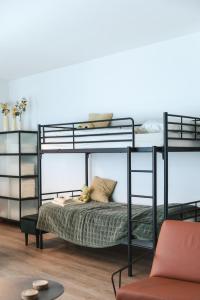 a black bunk bed with a teddy bear on it at Apartment The City in Ghent