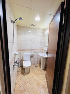 a bathroom with a toilet and a sink at Comfort Tourist Place for male in Dubai