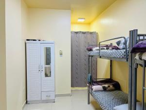 a room with three bunk beds and a door at Comfort Tourist Place for male in Dubai