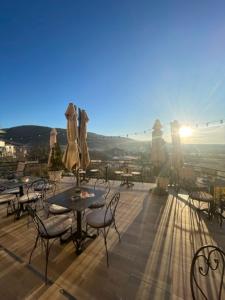 a balcony with tables and chairs and a view of a city at The Secret Garden in Ognyanovo