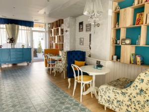 a living room with a table and chairs at The Secret Garden in Ognyanovo