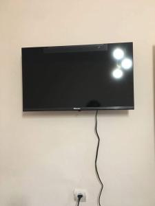 a flat screen tv hanging on a wall at Norik guest house in Garni