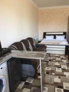 a living room with a couch and a bed at Norik guest house in Garni