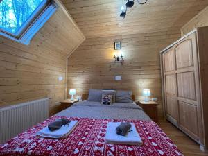 a bedroom with a bed in a wooden cabin at Casa Tudor in Padis