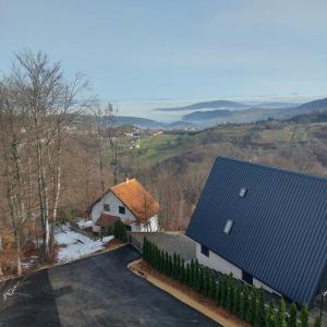 an aerial view of a house with a blue roof at Snežna idila in Zlatibor