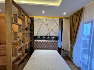 a bedroom with a bed and a window at PLEASURE LUX GOLD in Kopaonik