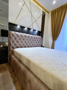 a large bed in a room with a large window at PLEASURE LUX GOLD in Kopaonik