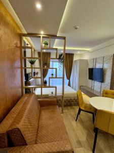 a living room with a couch and a bed at PLEASURE LUX GOLD in Kopaonik