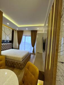 a hotel room with a bed and a chair at PLEASURE LUX GOLD in Kopaonik