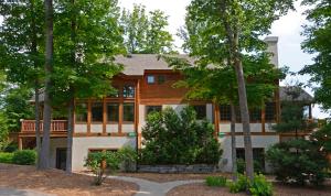 a home with trees in front of it at Boyne Mountain in Boyne Falls