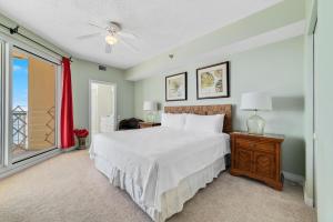 a bedroom with a bed and a window at Beach Colony Tower 12B in Perdido Key +47 photos
