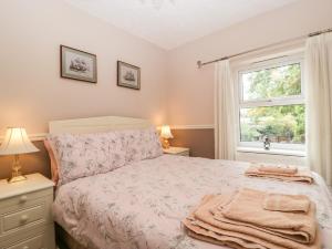 a bedroom with a bed and a window at 2 Bathsheba Terrace in Dorchester