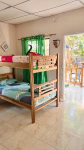 a bedroom with two bunk beds in a room at Sisio Hostal in Palomino