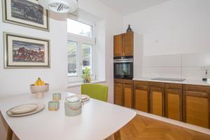 a kitchen with a white counter top and a table at Vila Krista in Maribor